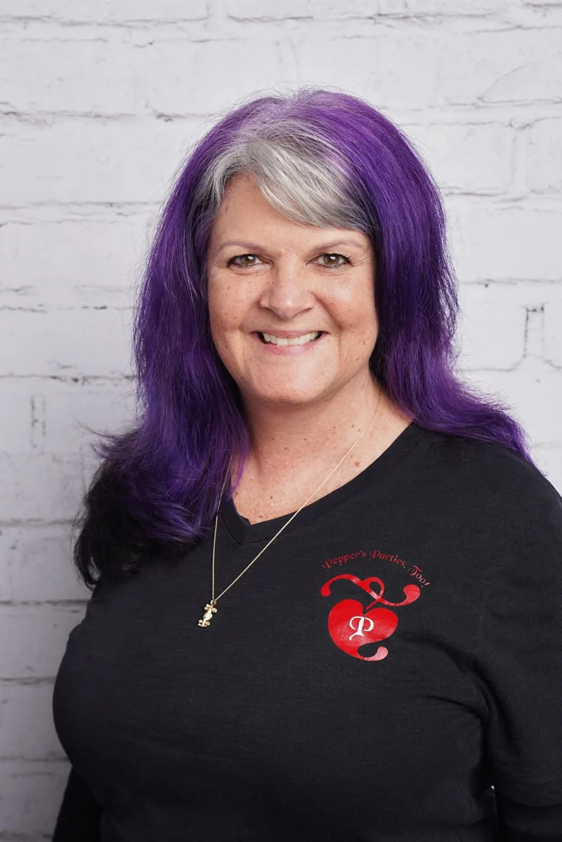 Kathi Pepper smiling, with silver and purple hair